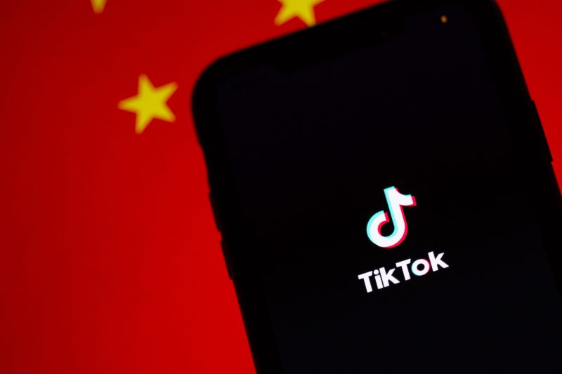 TikTok on a smartphone in front of a Chinese flag chine