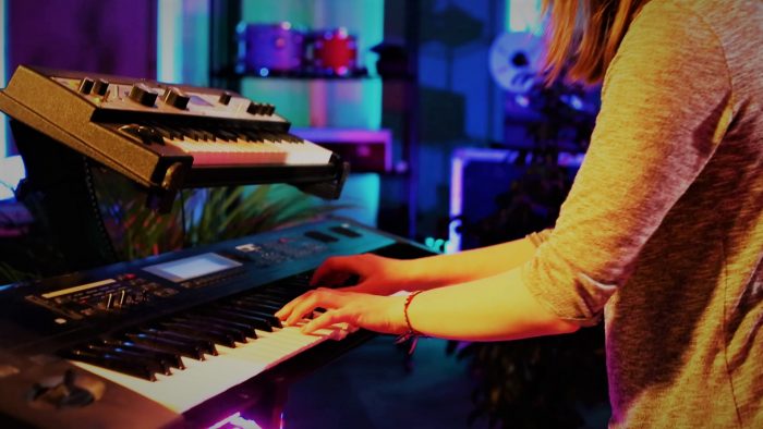 woman songwriting with keyboard