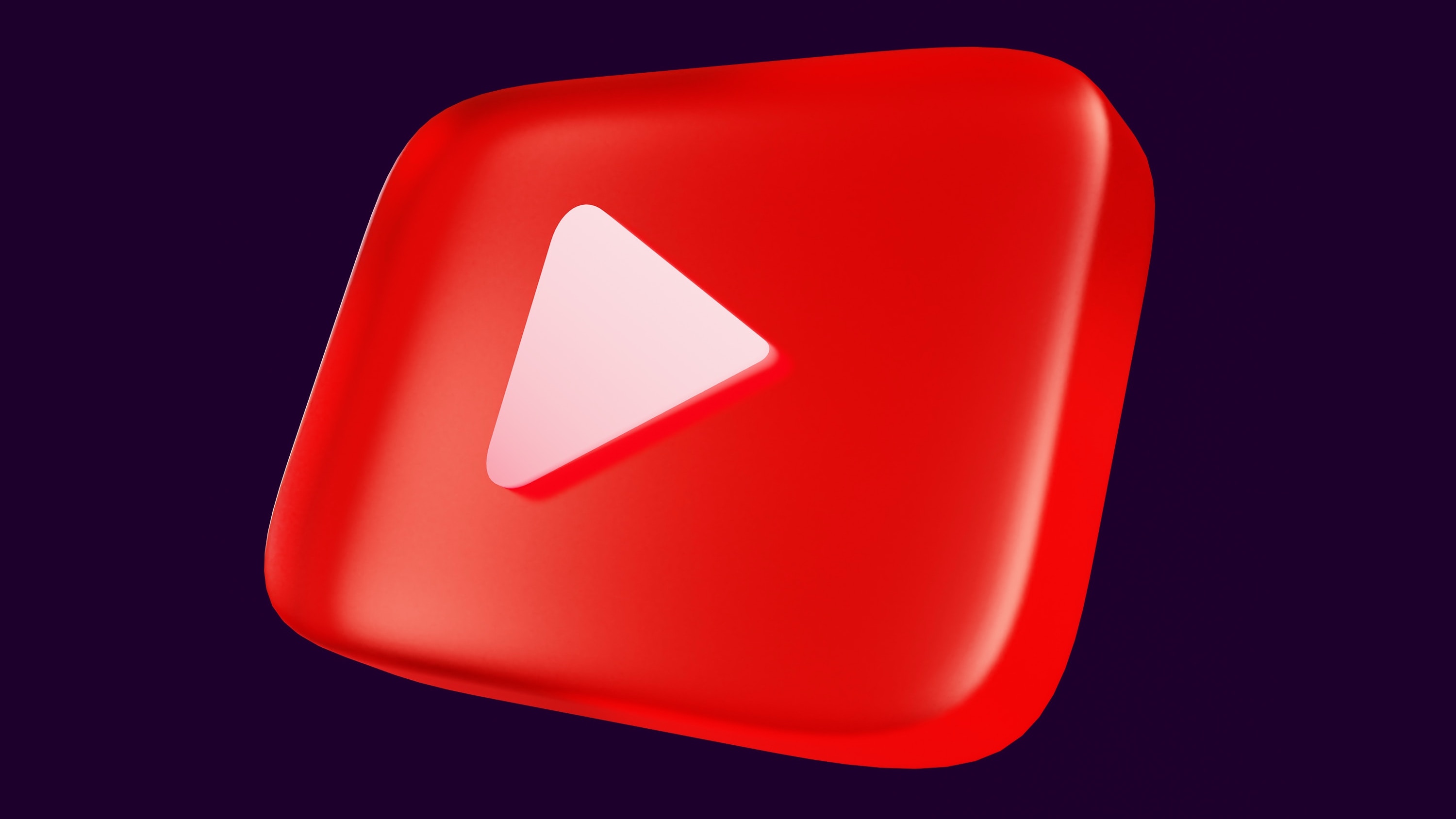 A 3D YouTube logo on a dark background