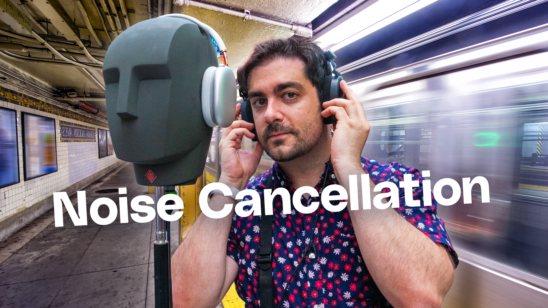 A dummy head and human, wearing headphones in the subway