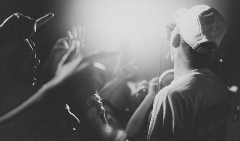 Artist with fans in black and white at a concert