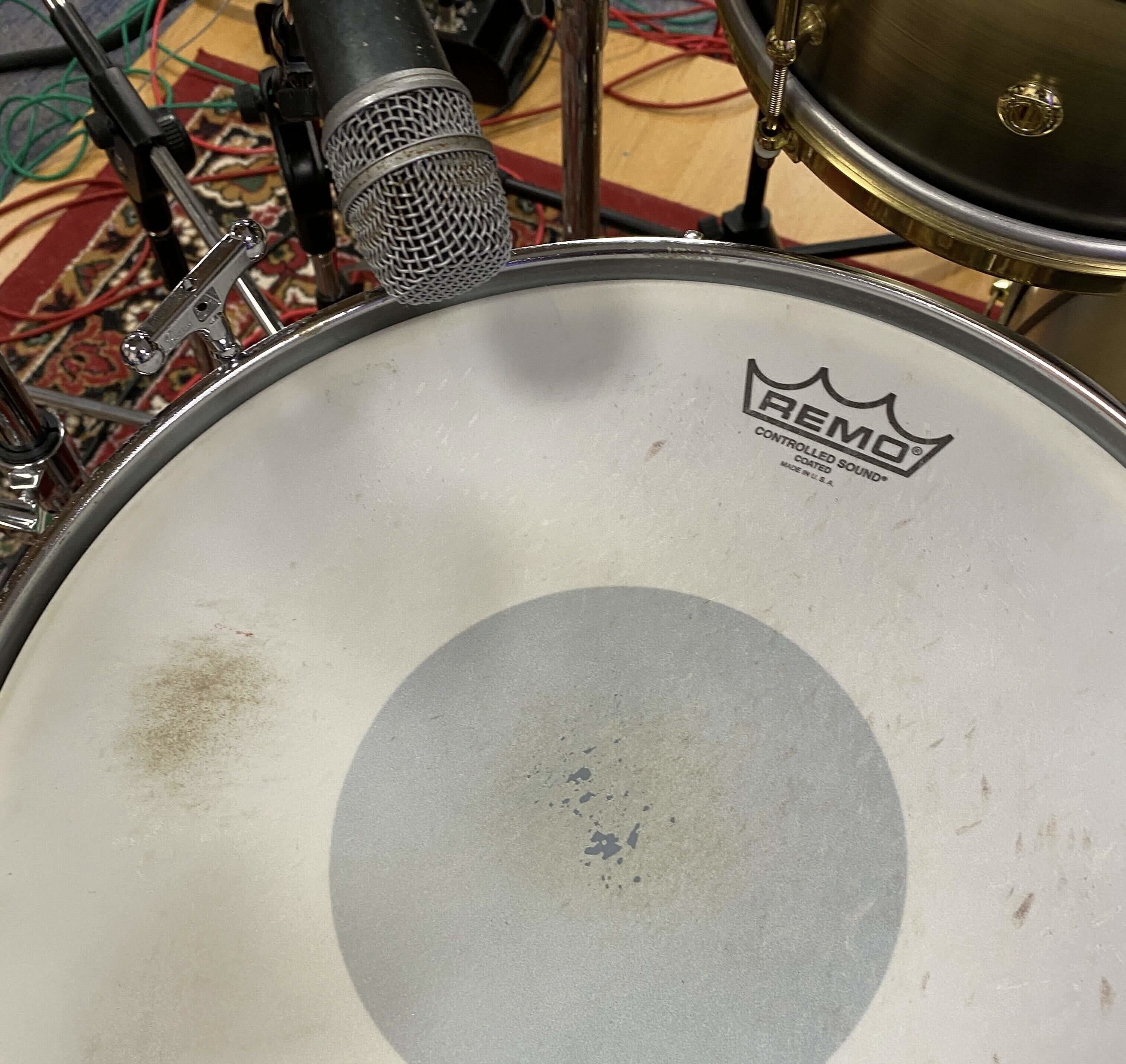 Place a dynamic microphone 1.5 to 2 inches above the snare, to the side, facing the centre.